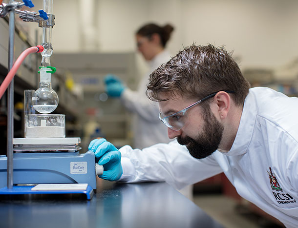 A student operating test equipment in an RCSI chemistry lab.
