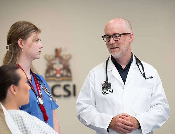 Doctor and medical student pictured at patients bedside