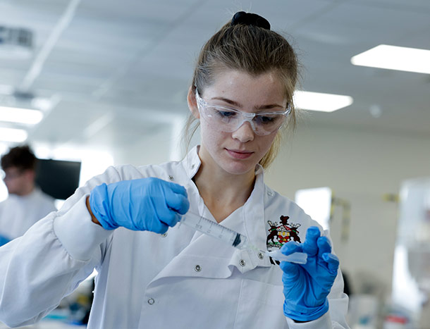 Female pharmacy student with syringe