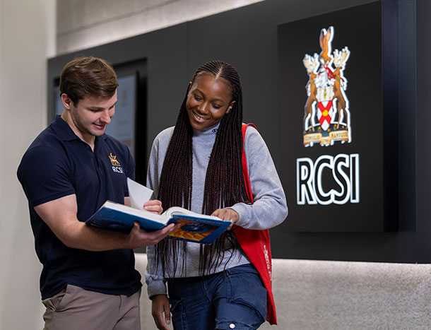 RCSI students looking at a book
