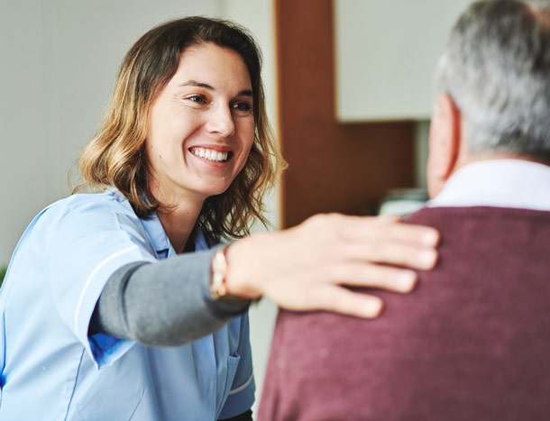 Healthcare professional smiling at patient