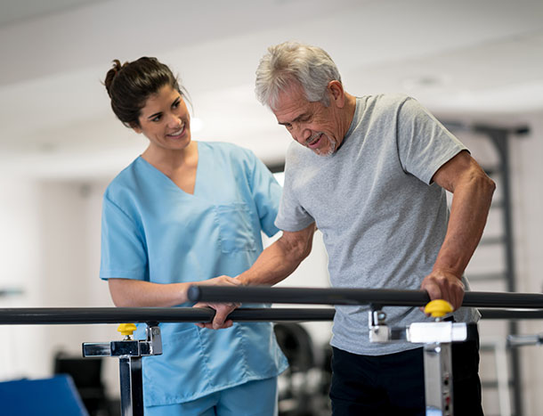 Man in rehab therapy with physiotherapist
