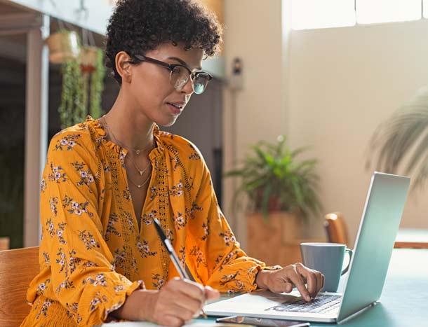 A person studies on a laptop at home