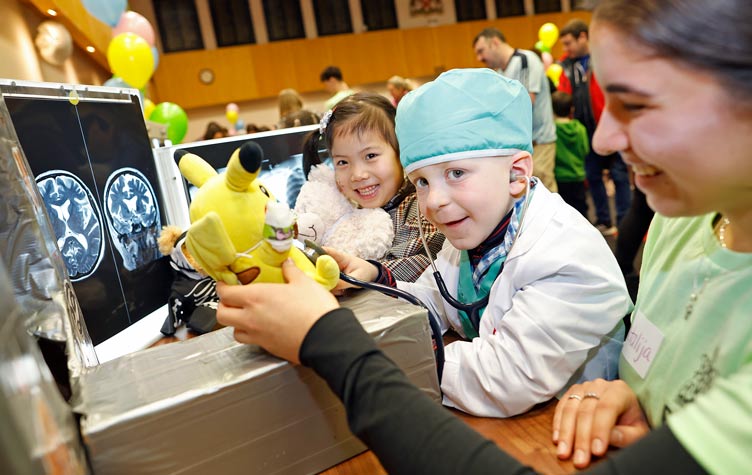 Children pose with smiles during Teddy Bear Hospital