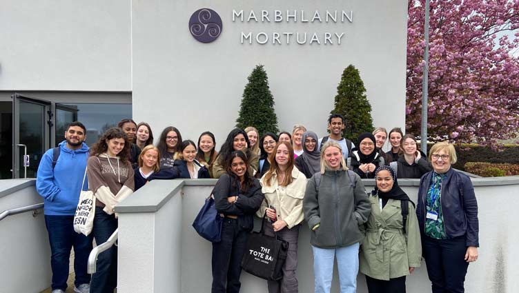 Group of students pose outside mortuary