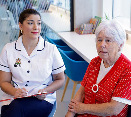 A nurse and an older person talking