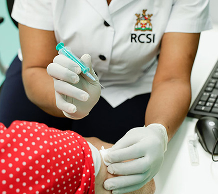 A nurse giving an elderly patient an injection.