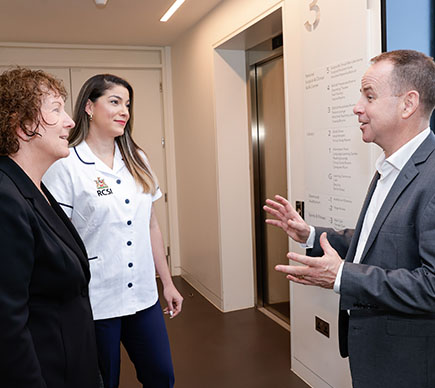  Senior nurses chatting in hallway 