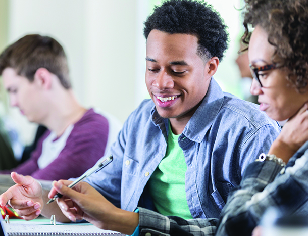 Group of young college students in a classroom environment.