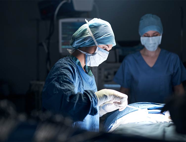 Female doctor operating in operating theatre