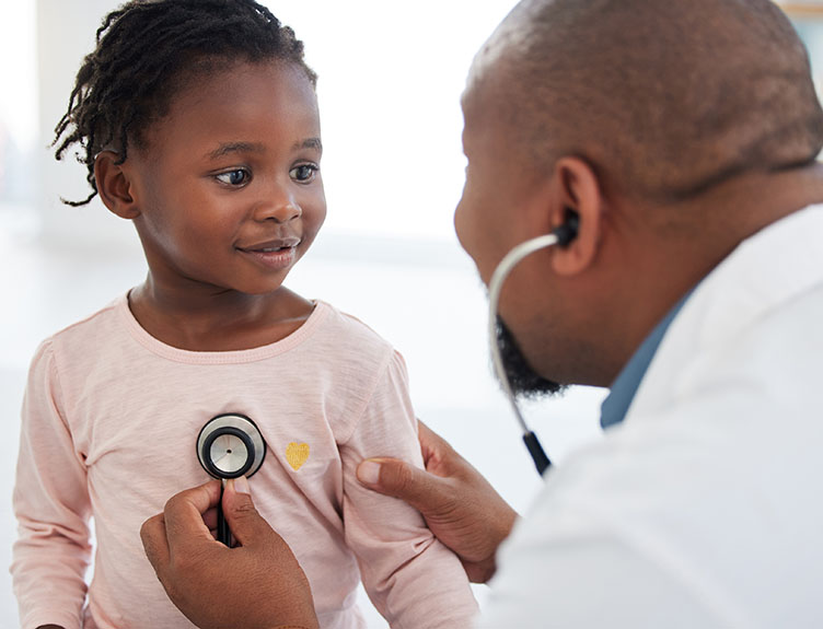 A paediatrician examines a baby girl with a stethoscope