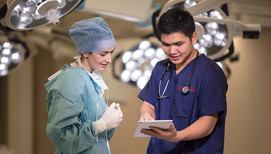 Student and surgeon working together
