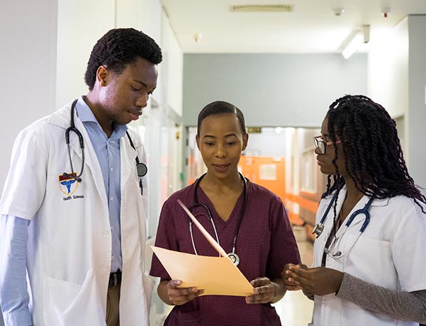 African doctor and nurse discussing file