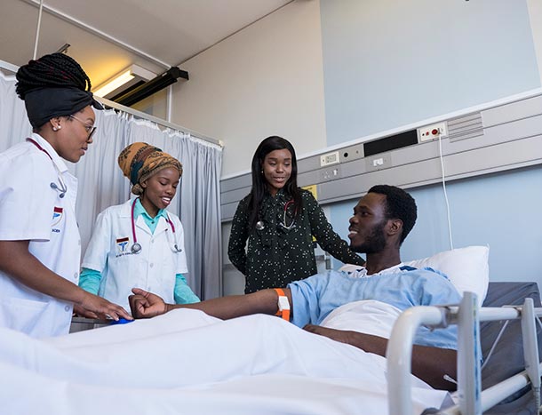 Female African doctors at patients bedside