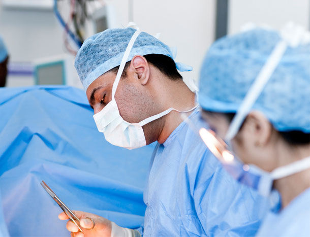 Focus on male surgeon operating