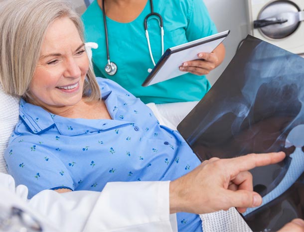 Patient looking at Xray in hospital bed