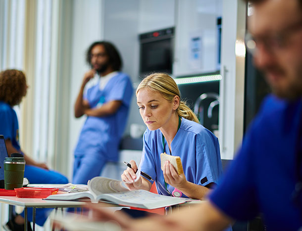 Young doctor studies while on lunch break